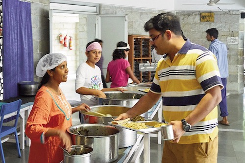 Food being served in the dining hall of Delhi Ashram